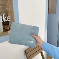 Detail of light blue corduroy makeup bag with woven Sozakka label in a cafe setting - Light Blue Grey