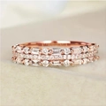 Macro shot of rose gold triple-layer ring with baguette and round-cut pavé diamonds - US 7 / Rose Gold