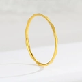 Macro shot of minimalist gold V-shaped ring with faceted geometric surface and reflections - US 5 / Gold V Faceted