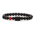 Detail of beaded bracelet with black tiger eye stones and Aries zodiac symbol bead - Aries Red Agate