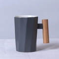 Dark grey matte ceramic mug with geometric facets and natural wooden handle - Decagonal Grey Mug