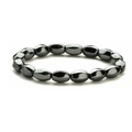 Macro view of polished oval hematite beads with metallic luster on elastic bracelet - Hematite