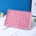 Pink velvet jewelry tray with multiple slots showcasing various rings for storage and display - Ring Row Tray