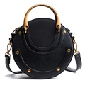 Matte black circular crossbody bag with gold hardware and studded crescent design - Black