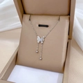 Detalle de collar de mariposa plateado con cadena doble y borlas de perlas en caja de regalo - Plateado