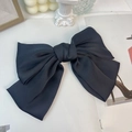 Elegant large black satin bow hair clip on a minimalist white artistic background - Black (Spring Clip)