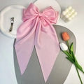 Detail of a large pink satin bow hair clip styled with tulips and a bubble candle - Pink Long Streamer