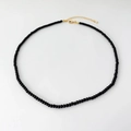 Detail of minimalist black agate beaded necklace with gold plated clasp and extension chain - 3mm Round Bead Necklace