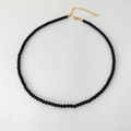 Detailed top view of black onyx beaded necklace with gold lobster clasp and extender - 4mm Round Bead Necklace