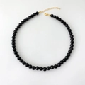 Polished black agate beads necklace with gold-plated lobster clasp on white background - 8mm Round Bead Necklace