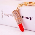 Sparkling lipstick keychain with red rhinestones and gold metal finish for women's bags - Red
