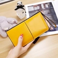 Long yellow PU leather wallet for women with zipper closure and wrist strap - Yellow