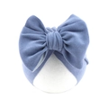 Detail shot of the large decorative bow and soft denim blue fabric on baby turban hat - Light Blue