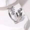 Minimalist silver leaf stainless steel open ring displayed on white textured stone - Adjustable Open / Silver