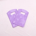 Macro detail of purple plastic jewelry bags featuring delicate cherry blossom prints - No. 33 (Purple Cherry Blossom)