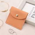 Macro shot of orange leather jewelry pouch featuring fine stitching and gold snap button - 8*8cm / Light Orange