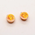 Detail showing a pair of realistic resin egg tart pendants with metal rings for DIY jewelry - Egg Tart