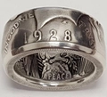 Macro shot of vintage 1928 coin ring with Peace and In God We Trust engravings - US 7 / 1928 Peace Dollar Antique Silver