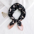 Elegant black and pink silk scarf featuring flamingo patterns tied in a chic bow - Black Flamingo