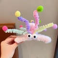 Close-up of a plush octopus hair claw clip with colorful spring tentacles and big eyes - Pink
