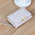 Short pink quilted faux leather wallet for women with pearl clasp and wrist strap on wood - Off-white