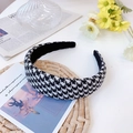 Flat lay of wide houndstooth sponge headband with decorative props in an ins-style setting - Large Grid