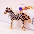 Portachiavi a forma di zebra dorata con strass e ciondoli di cristallo blu e viola - Zebra Dorata