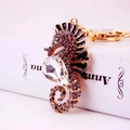 Classic seahorse keychain with sparkling rhinestones and a large crystal on golden metal - Gray