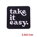 Square black embroidered patch featuring white 'take it easy.' text and stitched edges - take it easy