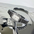 Detail of tonneau-shaped emerald quartz watch with crystal bezel and black metal strap - Gun Black White Dial