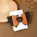 Detail of glitter Halloween bat hair clip with orange bow and pumpkin center on a card - Orange Pumpkin
