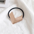Chic rose gold V-shaped brushed metal hair tie with black elastic band on white linen - Metal / Geometric Rose Gold