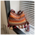 Detail of bohemian cross-body bag with ethnic embroidery patterns and colorful fringes - Brown