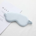 Light blue faux silk sleep mask with elastic strap on white magazine background - Mercerized Blue