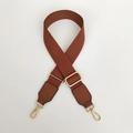 Detail of dark brown canvas bag strap with golden metal hooks and adjustable buckle - Brown / Silver