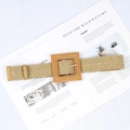 Close-up of beige woven straw belt with a square wood buckle on a lifestyle background - Big Square Buckle Khaki