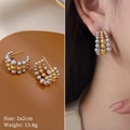 Macro detail and on-ear look of three-row beaded titanium steel hoop earrings in mixed tones - Gold Silver Mix (T122)