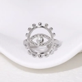 Macro shot of silver evil eye open ring with white zircon on a white background - Steel
