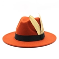 Detail of orange fedora wool felt hat with black ribbon and two gold feathers - M (56-58cm) / Rust red