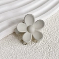 Close-up of a matte beige flower hair claw clip with a minimalist five-petal design - Gray