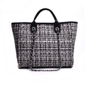 Close-up of black and white checkered tweed texture with silver chain strap on tote bag - Black