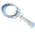 Detail of leopard print leather keychain bracelet with tassel and gold metal spring buckle - Deep Black Leopard