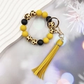 Close-up of leopard print and silicone beads bracelet keychain with yellow tassel - Yellow