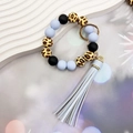 Close-up of leopard print and blue silicone bead keychain with luxury tassel detail - Blue