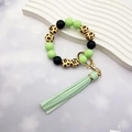 Close-up of leopard print wood and green silicone beads on a tassel wristlet keychain - Grass Green