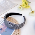 Detail of a wide houndstooth plaid headband placed on a clean INS style lifestyle background - Medium Grid