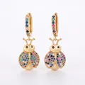 Close-up of golden ladybug earrings featuring multi-color zircon pavé settings - Ladybug Style