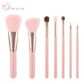 Close-up of 7-piece pink makeup brush set with rose gold ferrules and fiber bristles - 7Pcs Set / Girl Pink
