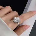 Rotating silver four-leaf clover ring with micro-pave crystals on female hand - Rotating Four-leaf Clover Style (640) / Silver