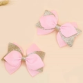 Pink ribbon and gold glitter bow hair clips for kids in a sweet minimalist flat lay style - Pink